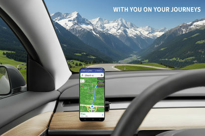 A smartphone mounted on a dashboard holder inside a car, displaying a navigation app screen. The phone is positioned on a wood-grain dashboard with a steering wheel in the foreground and a bridge view through the windshield. TESLA_MODEL_3_MODEL_Y_SUPER_MAGNET_DASH_PHONE_MOUNT_WITH_PRONGS_BUY_FROM_IRELAND_AND_EUROPES_TESLARY.EU